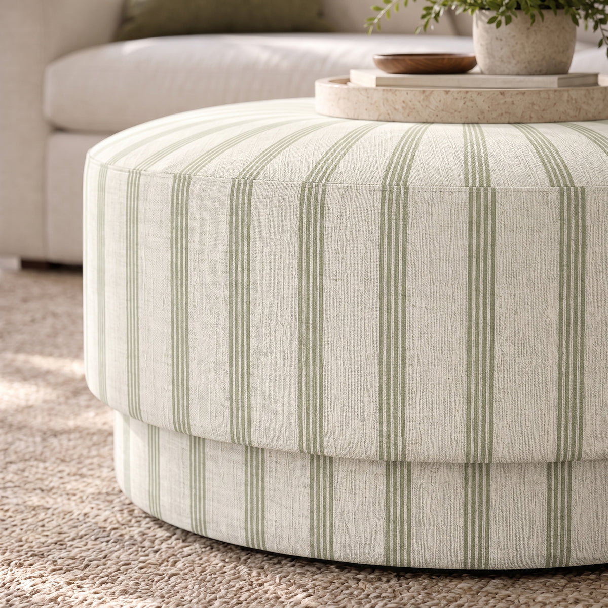 The Adelaide Ottoman in Orange County Olive Stripes